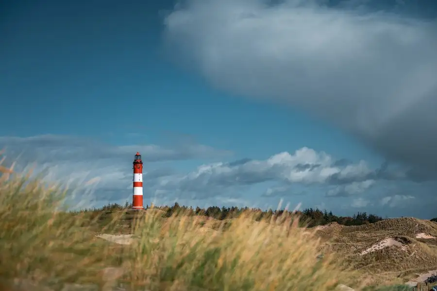 Der Amrumer Leuchtturm steht im Süden der nordfriesischen Insel und ist eines ihrer Wahrzeichen. Mit dem herbstlichen Wolkenspiel wirkt der Leuchtturm besonders beeindruckend. Der Amrumer Leuchtturm steht im Süden der nordfriesischen Insel und ist eines ihrer Wahrzeichen. Mit dem herbstlichen Wolkenspiel wirkt der Leuchtturm besonders beeindruckend.
